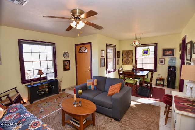 tiled living room with a healthy amount of sunlight and ceiling fan