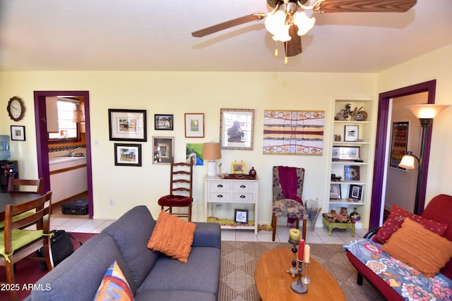 living room with light tile patterned floors, ceiling fan, and built in shelves