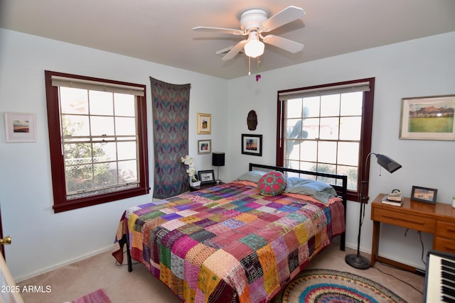 carpeted bedroom featuring ceiling fan and multiple windows