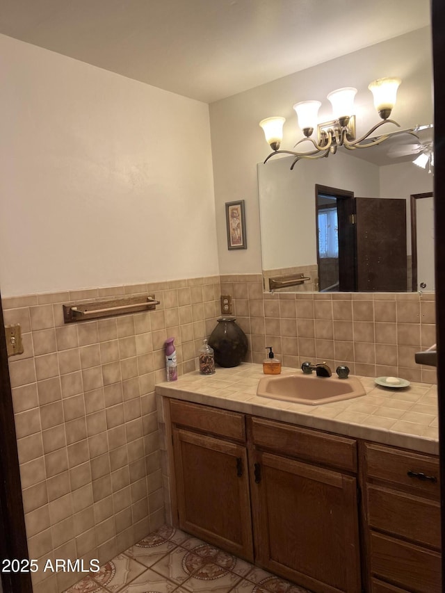 bathroom featuring tile walls, tile patterned flooring, and vanity