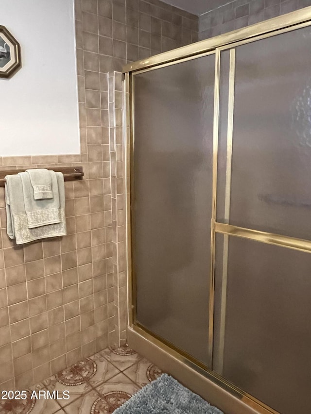 bathroom featuring a shower with door