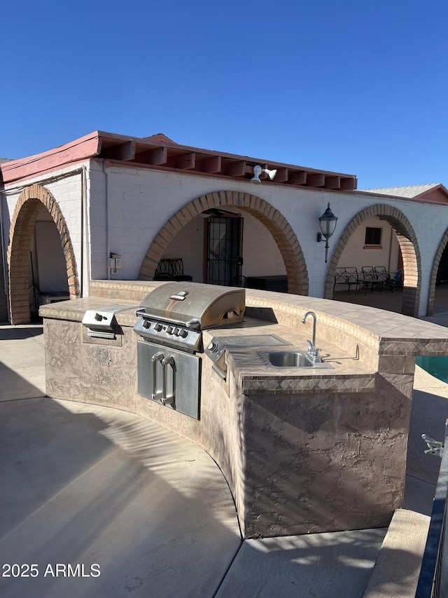 view of patio / terrace featuring sink, exterior kitchen, and grilling area