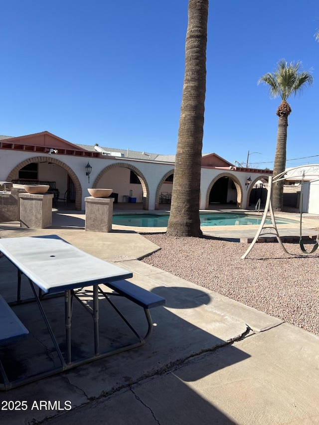 exterior space featuring an outdoor kitchen and a patio area