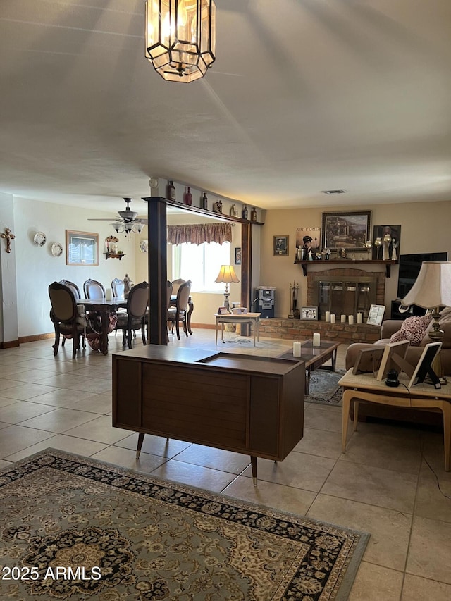 living room featuring ceiling fan with notable chandelier and light tile patterned flooring