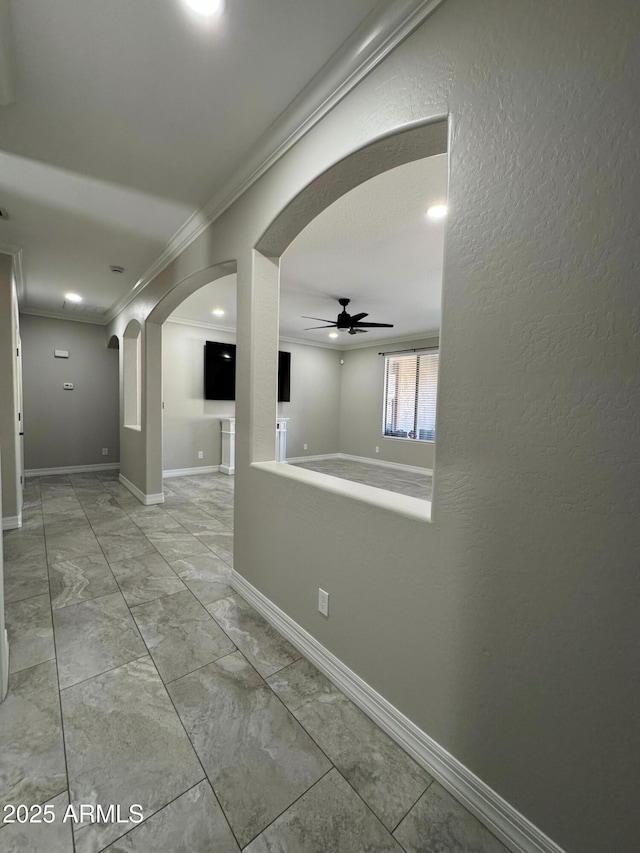 spare room featuring ornamental molding and ceiling fan