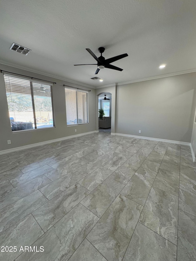 empty room featuring ceiling fan, crown molding, and a textured ceiling