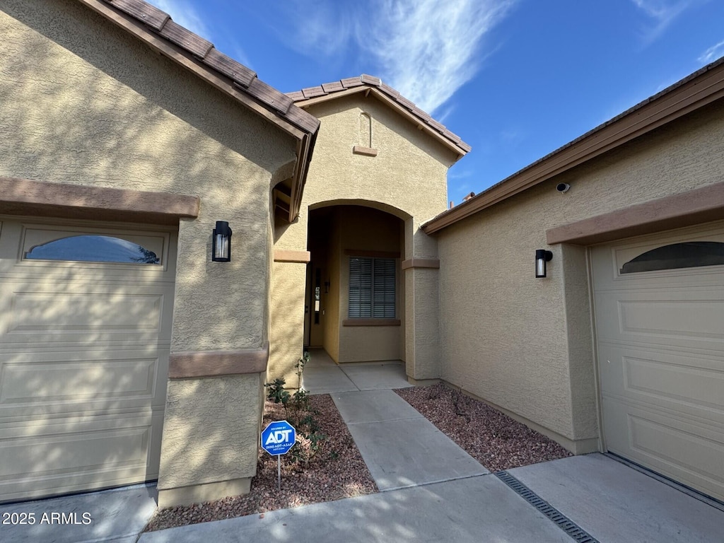 view of exterior entry featuring a garage