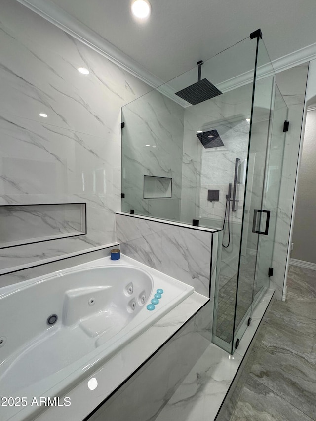 bathroom with ornamental molding and shower with separate bathtub