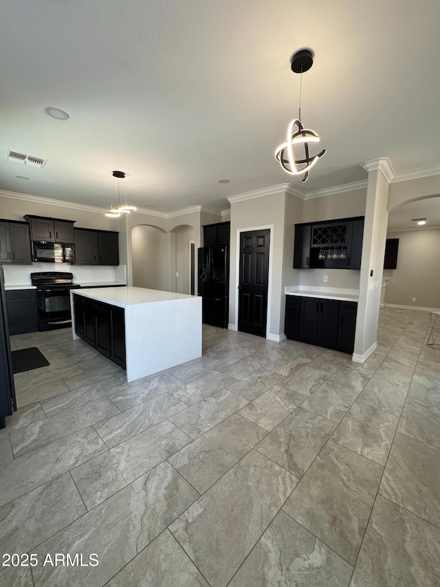 kitchen featuring a kitchen island, pendant lighting, crown molding, and black appliances