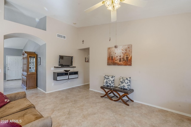 tiled living room with ceiling fan