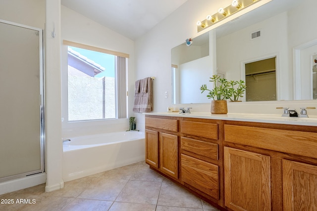 bathroom featuring lofted ceiling, vanity, tile patterned floors, and independent shower and bath