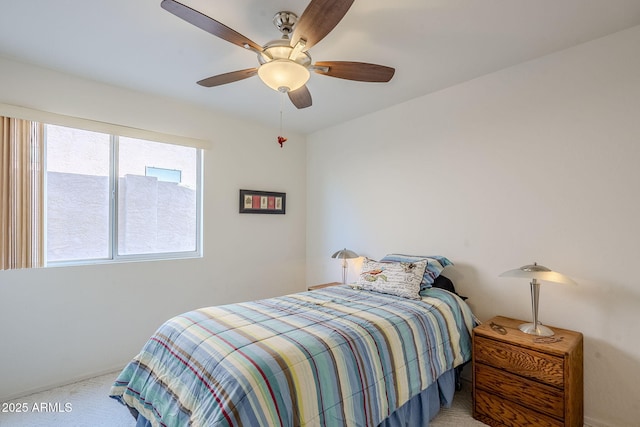 bedroom featuring ceiling fan and light carpet