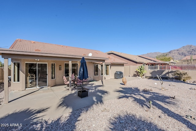 rear view of property with a patio and a mountain view