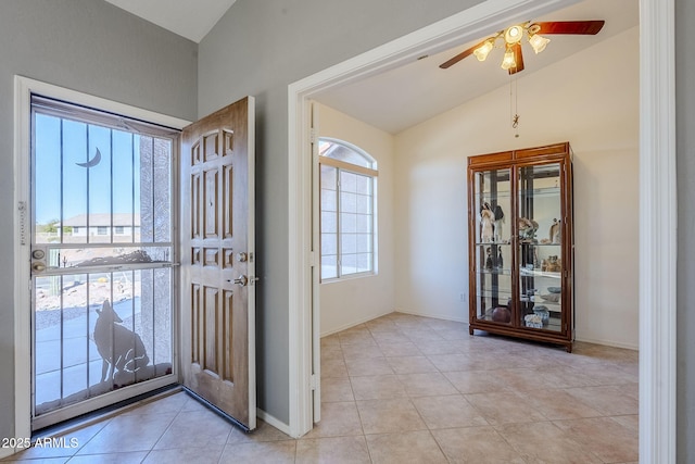 tiled foyer featuring a healthy amount of sunlight, ceiling fan, and lofted ceiling