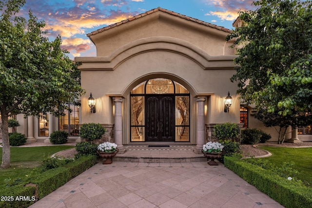 9451 E Happy Valley Rd, Scottsdale, AZ 85255 - property entrance with a lawn, french doors, and stucco siding