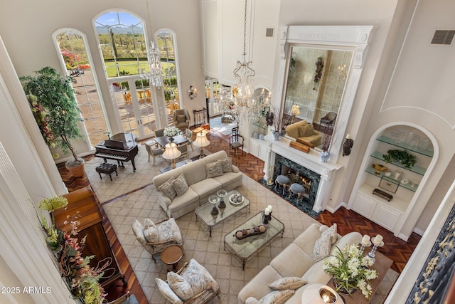 9451 E Happy Valley Rd, Scottsdale, AZ 85255 - living area featuring a high end fireplace, visible vents, built in shelves, and a high ceiling
