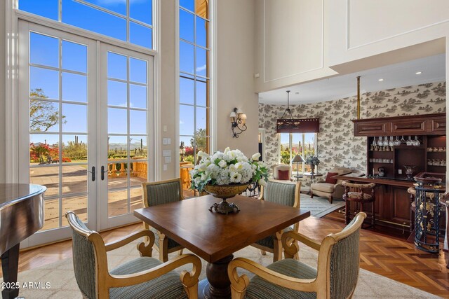 9451 E Happy Valley Rd, Scottsdale, AZ 85255 - dining area featuring wallpapered walls, french doors, and a towering ceiling