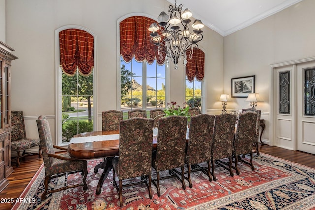9451 E Happy Valley Rd, Scottsdale, AZ 85255 - dining area with vaulted ceiling, wood finished floors, crown molding, and an inviting chandelier