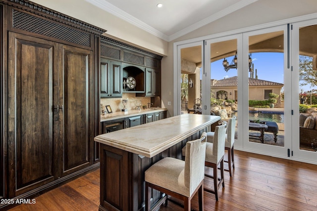 9451 E Happy Valley Rd, Scottsdale, AZ 85255 - kitchen featuring a kitchen breakfast bar, dark brown cabinets, recessed lighting, light countertops, and dark wood-type flooring