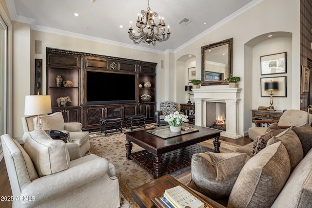 9451 E Happy Valley Rd, Scottsdale, AZ 85255 - living room featuring recessed lighting, a warm lit fireplace, visible vents, ornamental molding, and arched walkways