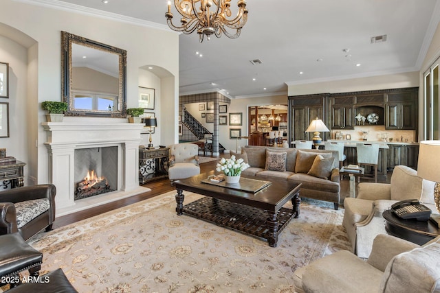 9451 E Happy Valley Rd, Scottsdale, AZ 85255 - living area with recessed lighting, wood finished floors, arched walkways, a lit fireplace, and stairs
