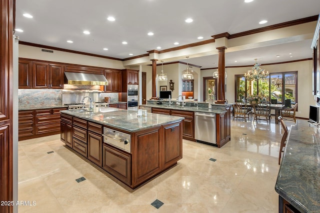 9451 E Happy Valley Rd, Scottsdale, AZ 85255 - kitchen with a large island, appliances with stainless steel finishes, backsplash, ornamental molding, and ornate columns