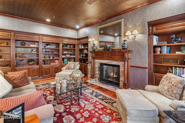 9451 E Happy Valley Rd, Scottsdale, AZ 85255 - living room featuring a high end fireplace, wood finished floors, and ornamental molding