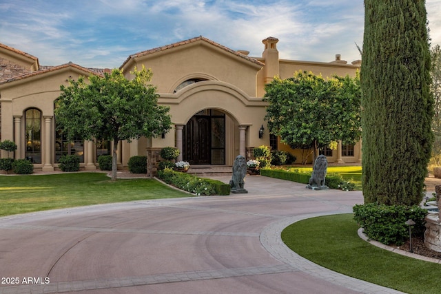 9451 E Happy Valley Rd, Scottsdale, AZ 85255 - mediterranean / spanish house with a front lawn, curved driveway, and stucco siding