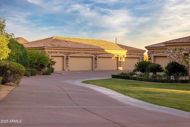 9451 E Happy Valley Rd, Scottsdale, AZ 85255 - mediterranean / spanish-style house with stone siding, a tiled roof, a front lawn, and stucco siding