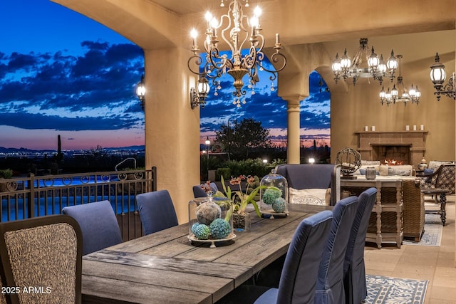 9451 E Happy Valley Rd, Scottsdale, AZ 85255 - dining area featuring arched walkways, an inviting chandelier, and a warm lit fireplace