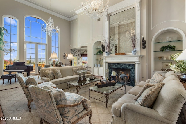 9451 E Happy Valley Rd, Scottsdale, AZ 85255 - living area featuring built in shelves, a towering ceiling, a chandelier, and plenty of natural light