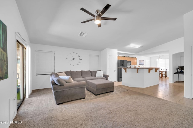 16887 W Belleview St, Goodyear, AZ 85338 - living room with lofted ceiling, light carpet, a ceiling fan, light tile patterned floors, and baseboards