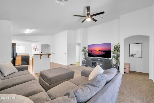 16887 W Belleview St, Goodyear, AZ 85338 - living area featuring arched walkways, ceiling fan, and light carpet