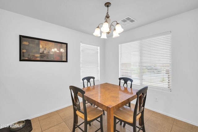 16887 W Belleview St, Goodyear, AZ 85338 - dining area with a chandelier, light tile patterned floors, and baseboards