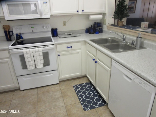 kitchen featuring white cabinetry, white appliances, sink, and light tile patterned floors