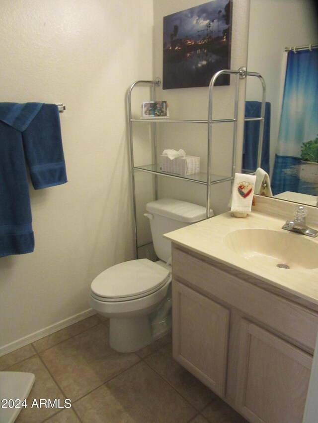 bathroom with tile patterned flooring, vanity, and toilet