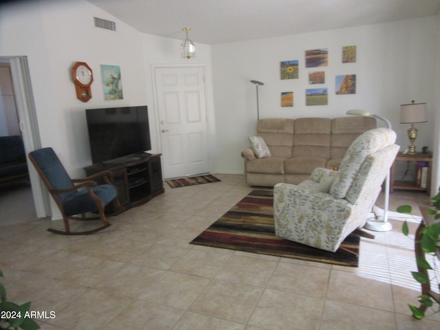 tiled living room featuring vaulted ceiling