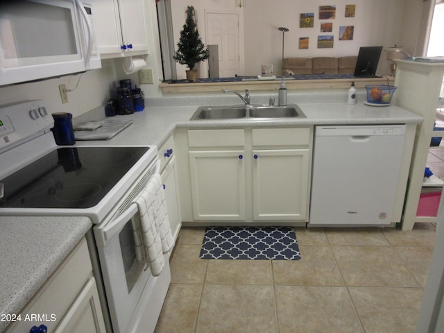 kitchen with white appliances, sink, and light tile patterned floors