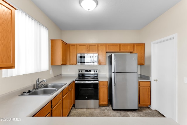 4234 S 62nd Ln, Phoenix, AZ 85043 - kitchen featuring a sink, stainless steel appliances, brown cabinetry, and light countertops