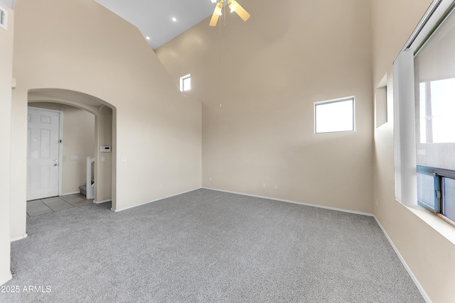 4234 S 62nd Ln, Phoenix, AZ 85043 - empty room featuring visible vents, carpet floors, arched walkways, ceiling fan, and a towering ceiling
