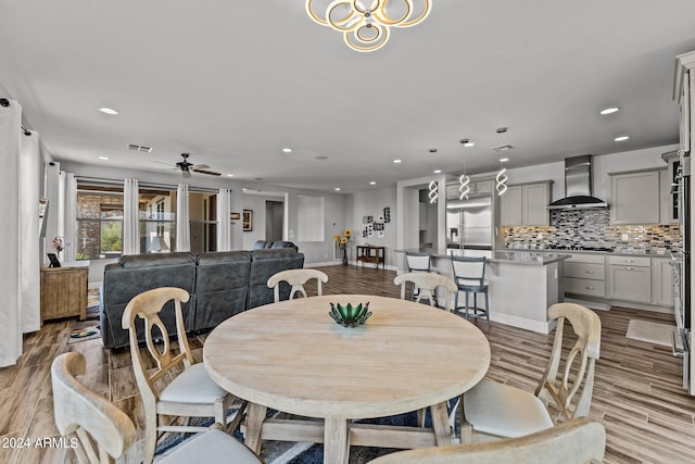 dining area featuring ceiling fan and light hardwood / wood-style floors