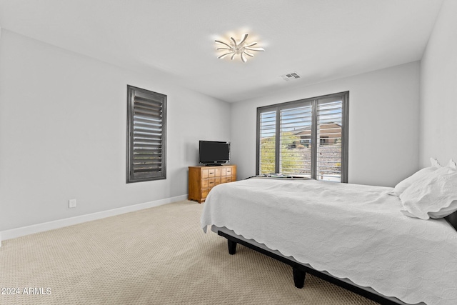 bedroom featuring light carpet