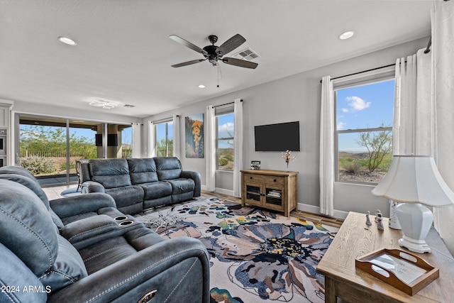 living room with a wealth of natural light, ceiling fan, and hardwood / wood-style flooring