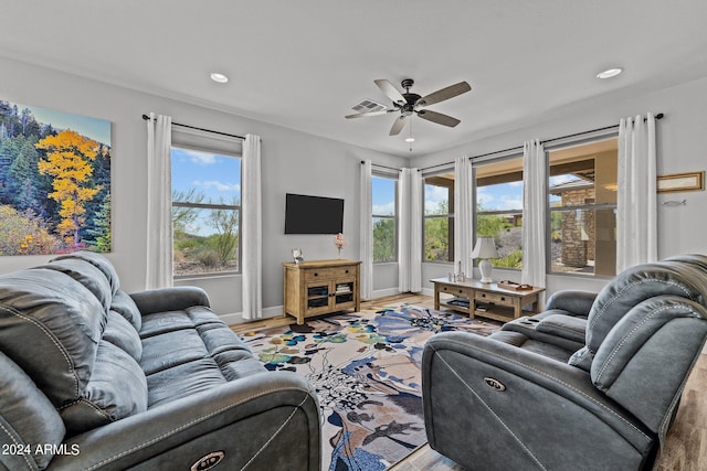 living room with ceiling fan, light hardwood / wood-style flooring, and plenty of natural light