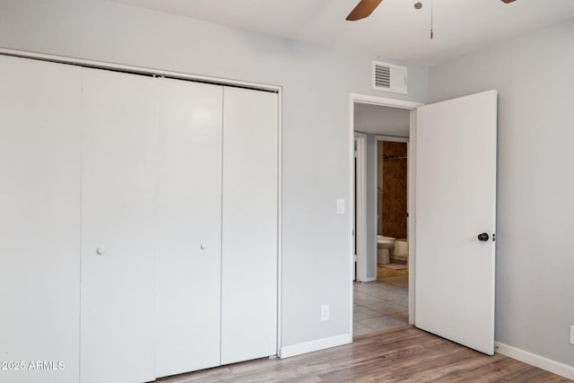 unfurnished bedroom featuring visible vents, a closet, light wood-style floors, baseboards, and ceiling fan