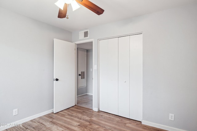 unfurnished bedroom with visible vents, light wood-type flooring, and baseboards