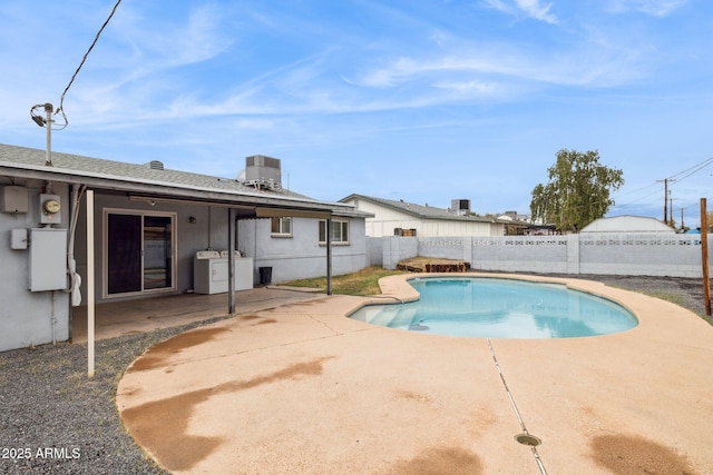 view of pool featuring a fenced in pool, central air condition unit, washer / dryer, a fenced backyard, and a patio area