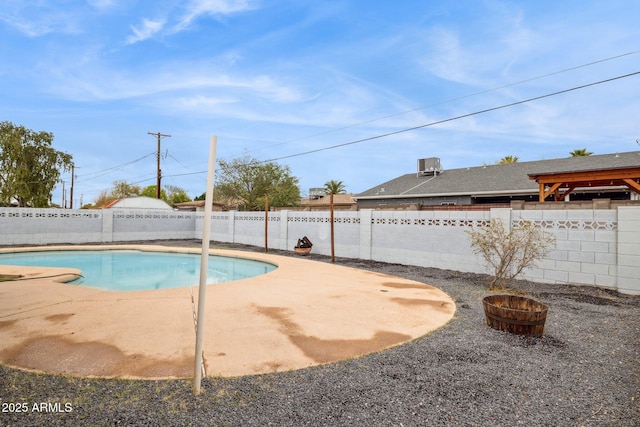 view of swimming pool featuring a fenced backyard, a fenced in pool, and a patio