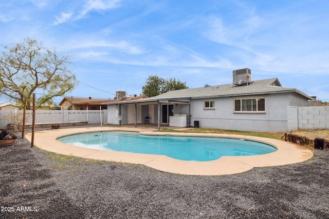 view of swimming pool with cooling unit, a fenced in pool, a patio, and a fenced backyard