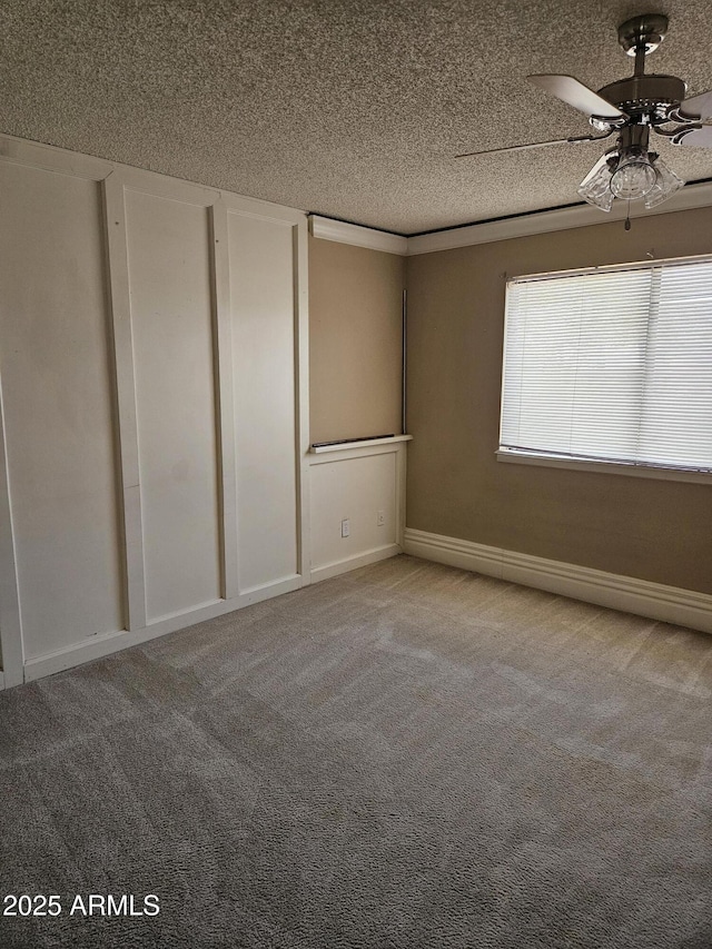 spare room featuring light carpet, a textured ceiling, and ceiling fan